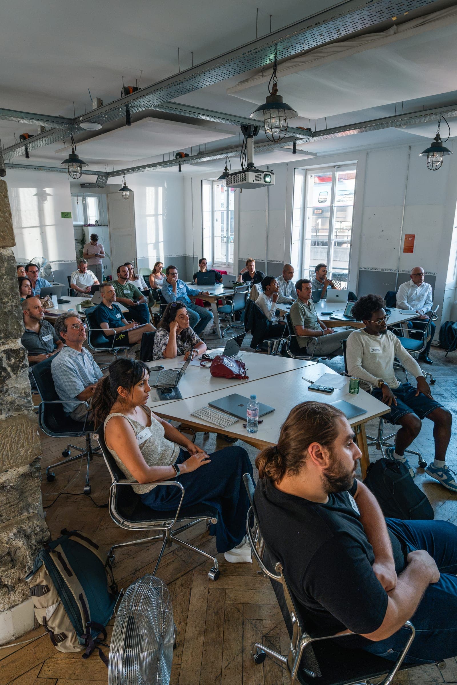 Seated audience looking toward the front of the workshop room at Impact Hub Geneva