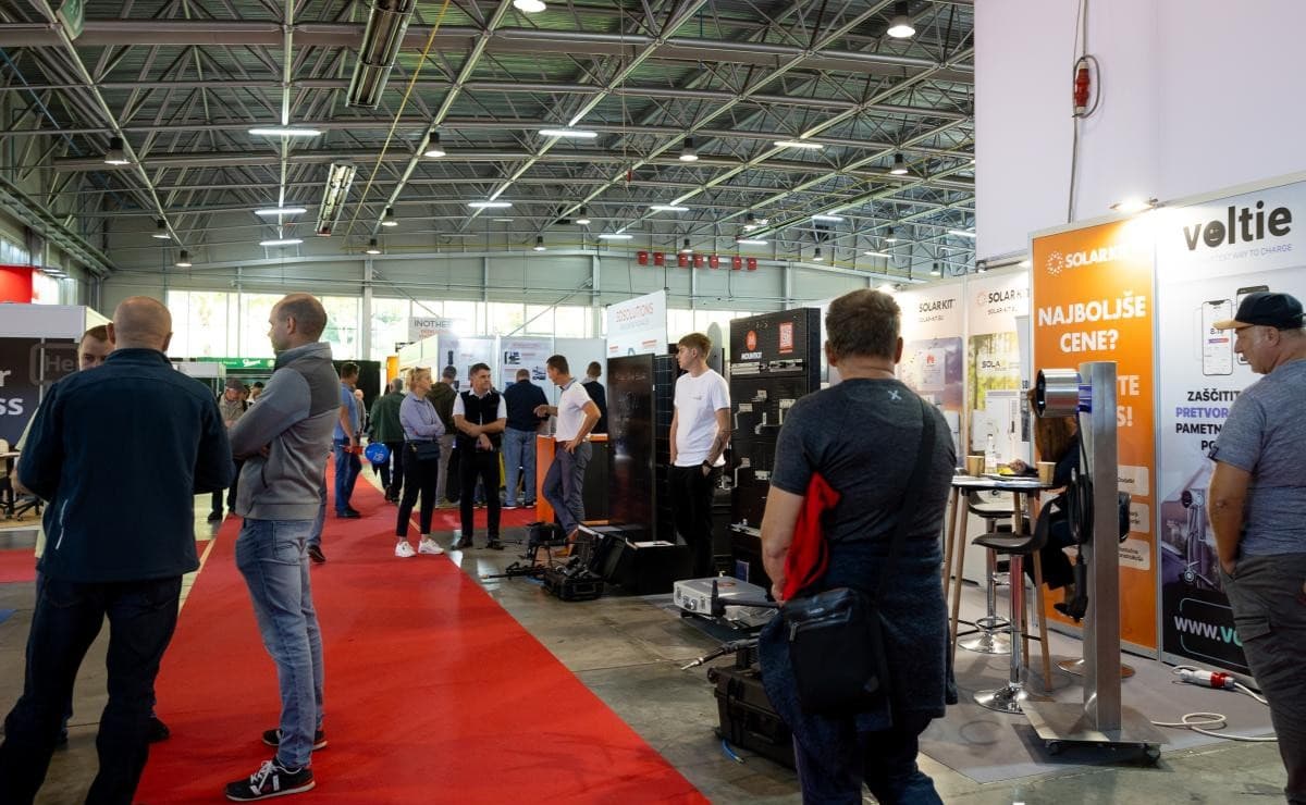 Visitors in the Hall K aisle beside the SolarKit stand