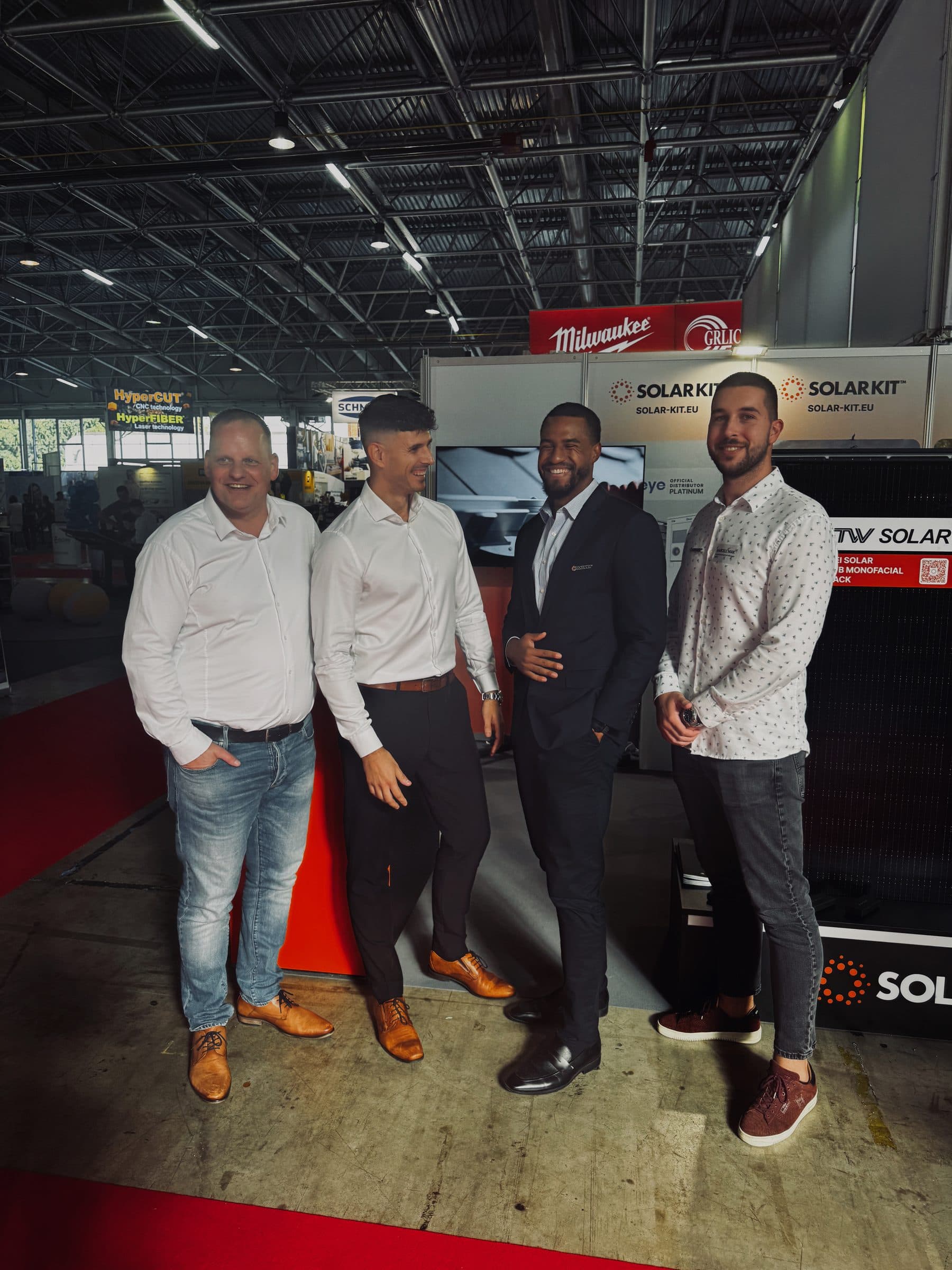 Four exhibitors in front of the SolarKit panels at stand K-22