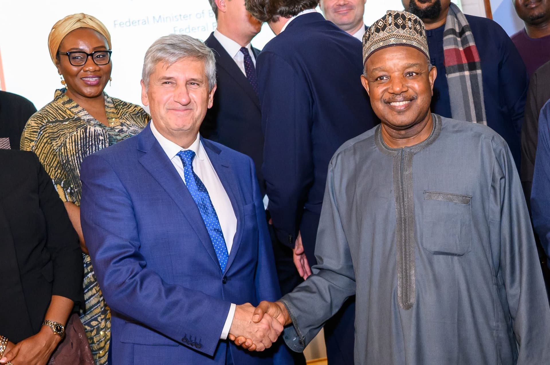 The Minister greeting guests with a handshake at the reception