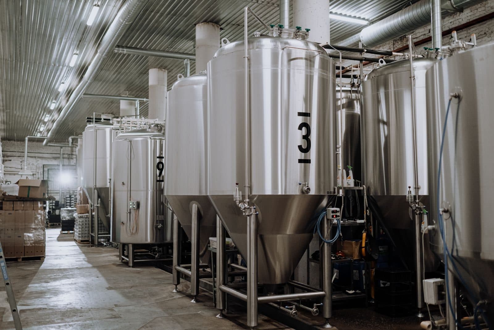 Stainless process tanks on a production floor