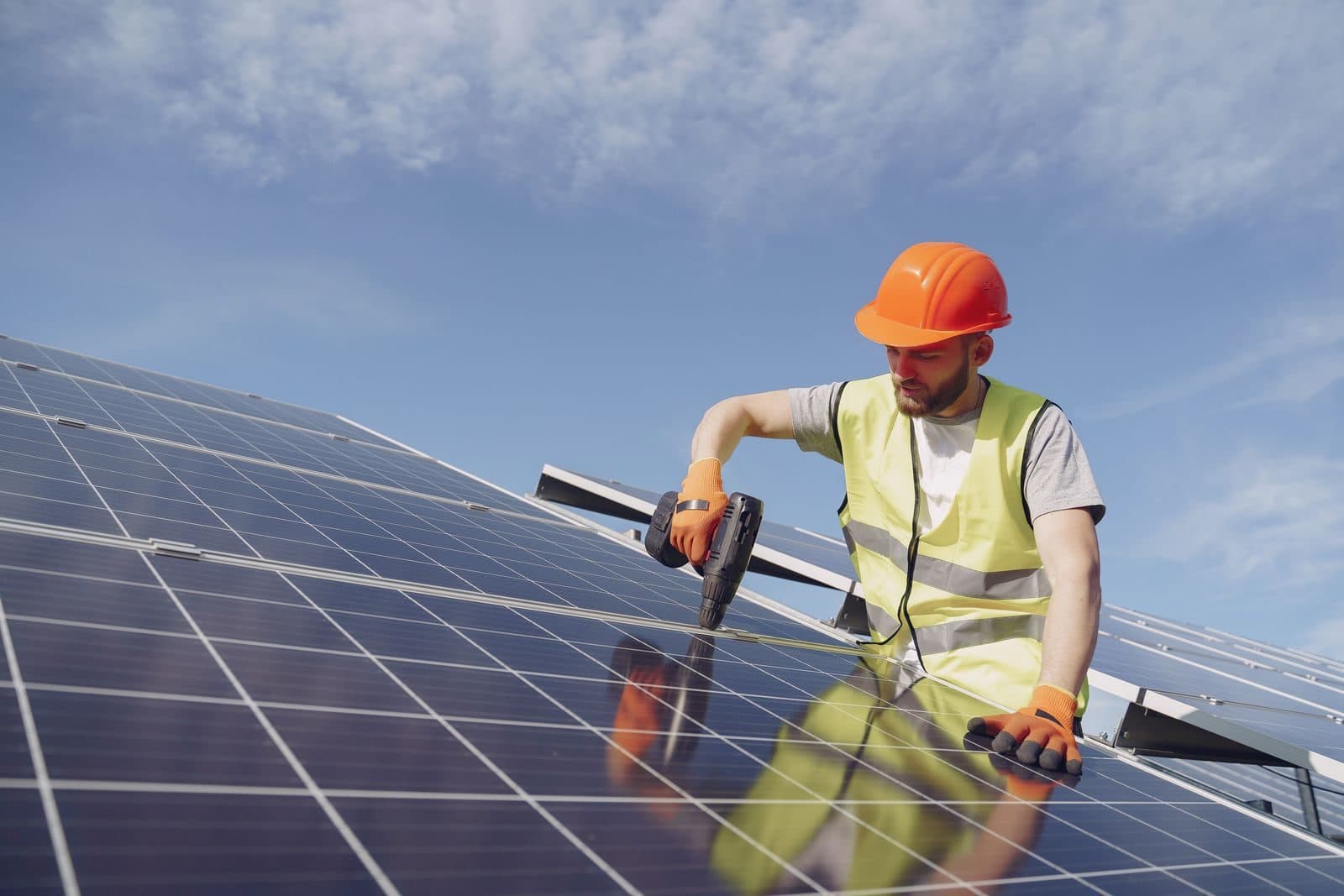Technician working on a photovoltaic module in the sun